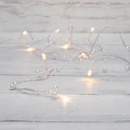 Гирлянда светодиодная Жемчужинки 15 м 10 LED прозрачный ПВХ цвет свечения теплый белый 2 х АА батарейки не в комплекте NEONNIGHT 303097